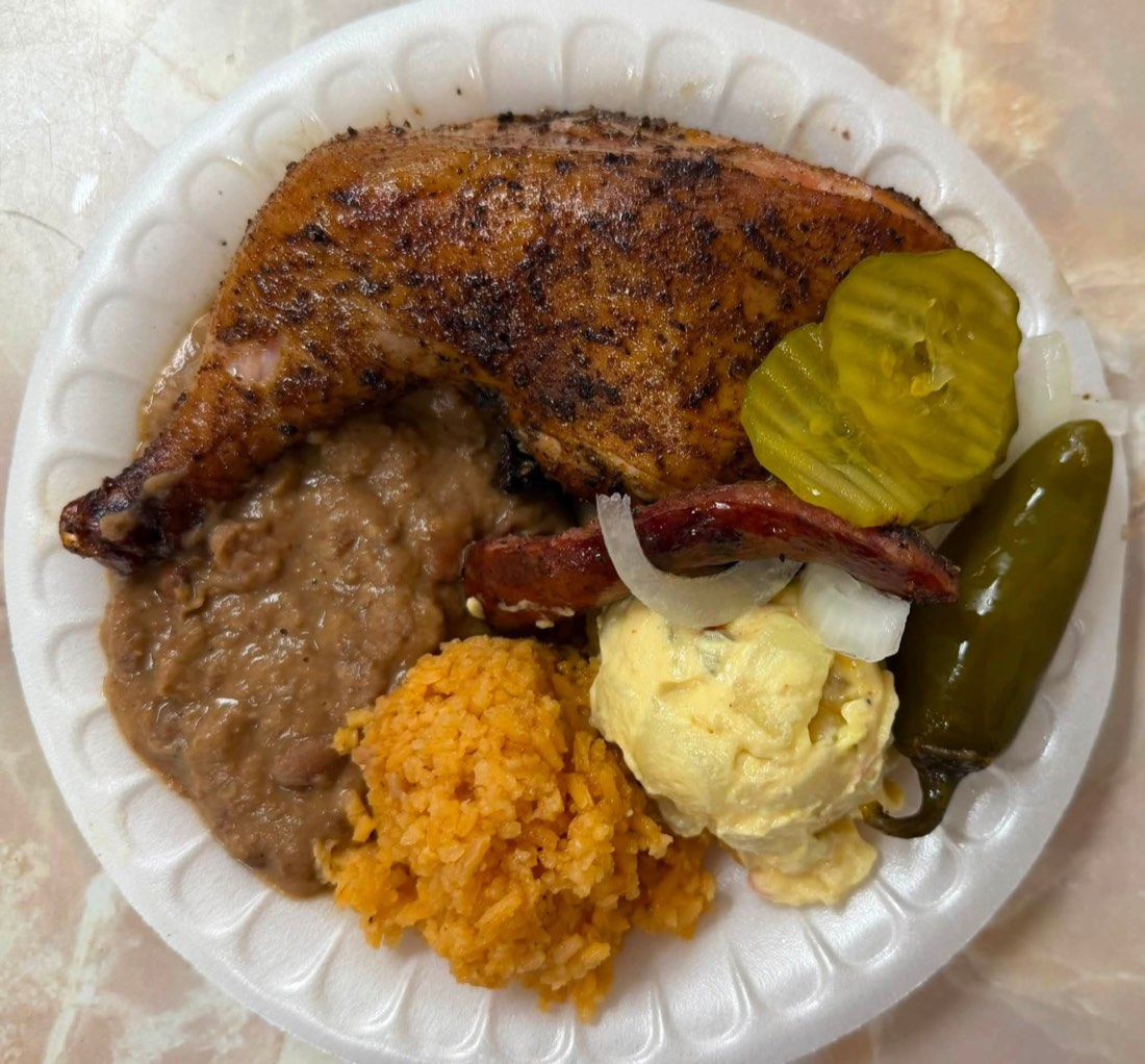 Catering tray with smoked chicken, sausage, sliced brisket, and ribs