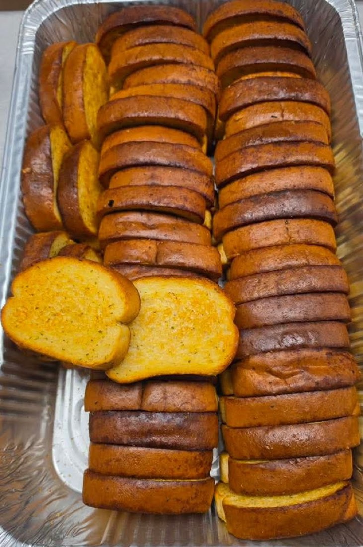 Pan of slow-cooked pinto beans with a serving spoon