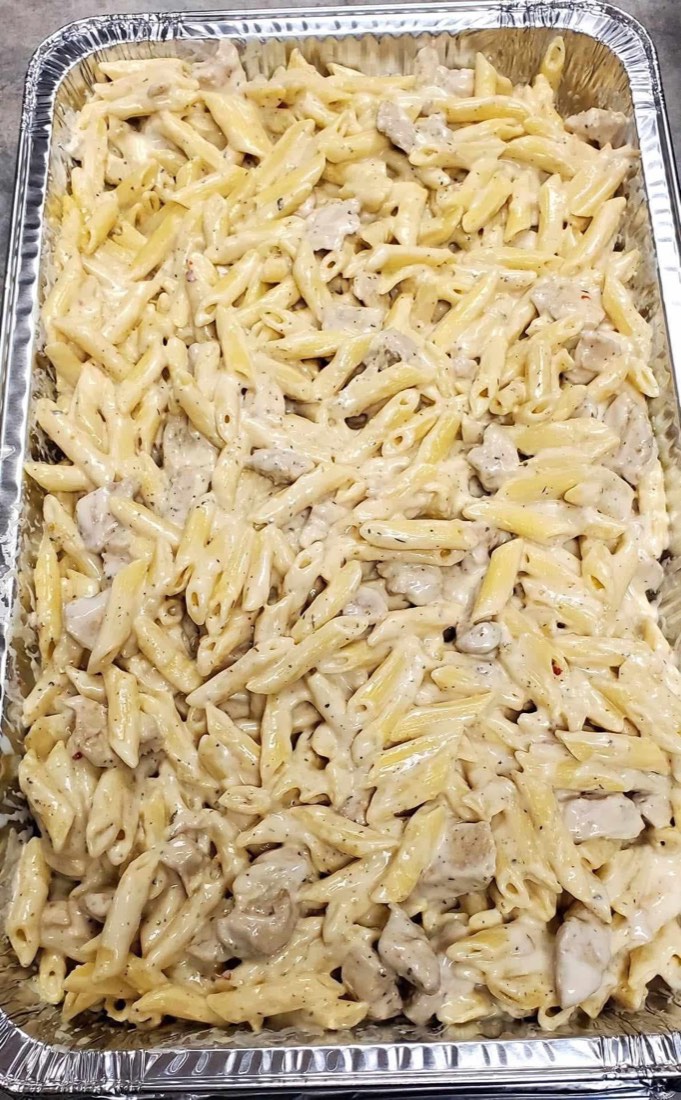 Large foil tray of creamy chicken Alfredo penne