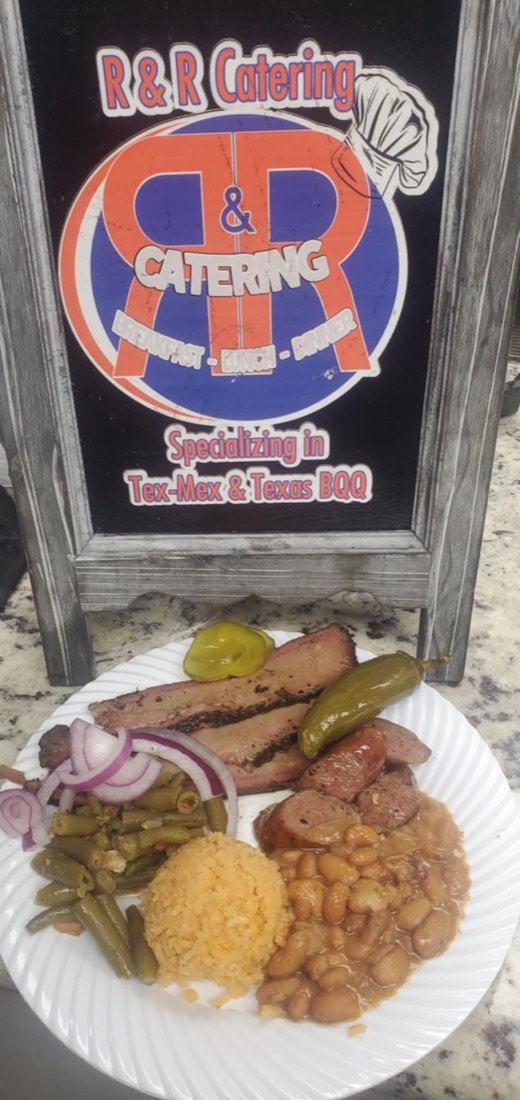 Plate of brisket, sausage, beans, Spanish rice, green beans, peppers, and onions