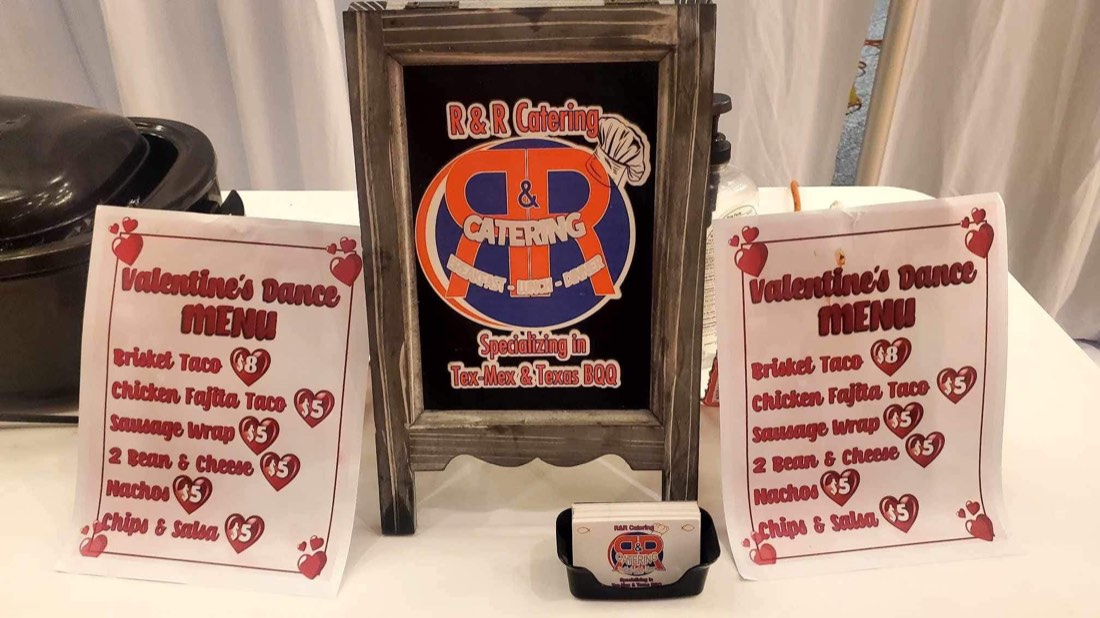 R&R Catering display between printed Valentine dance menus and business cards